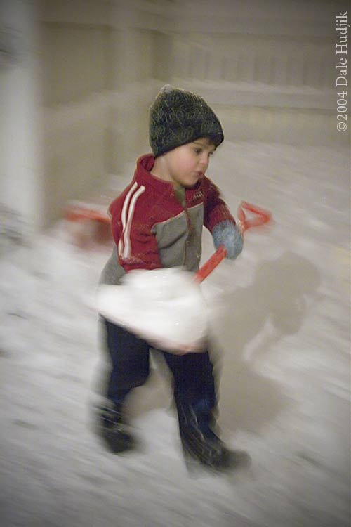 4 year old boy shovelling snow