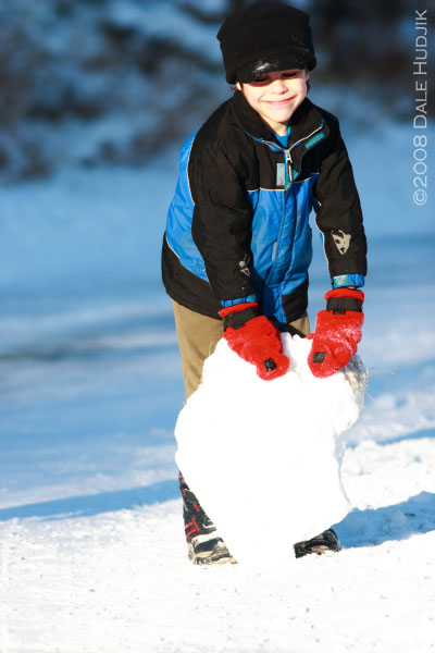 little boy playing in snow